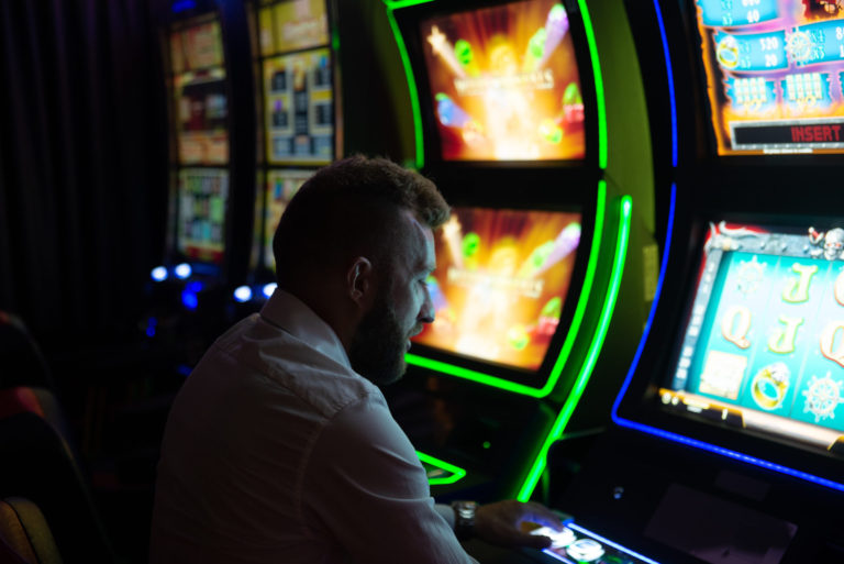 Man playing a slot machine
